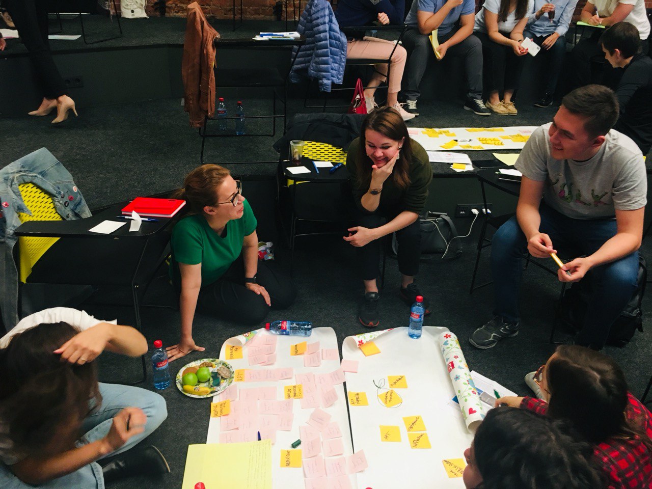 People are sitting on the floor talking.